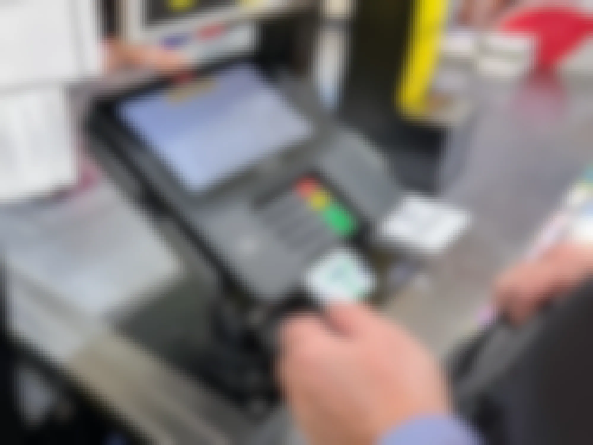 Someone paying at a Dollar General checkout using a card