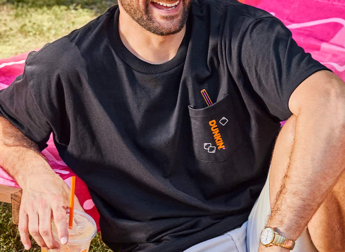 a man wearing a dunkin oversized t-shirt 