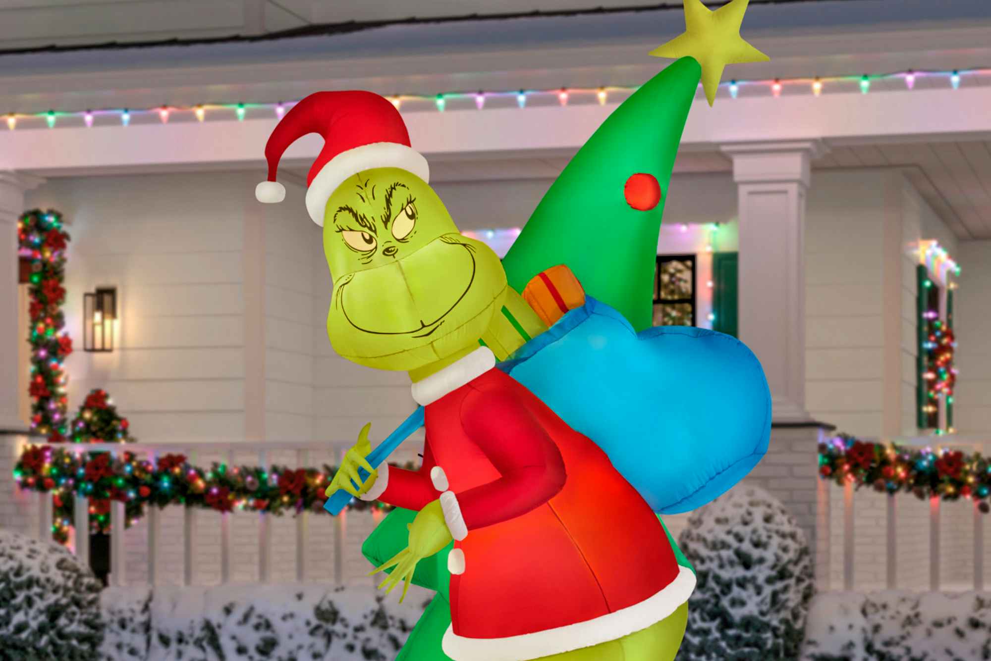 The Home Depot Grinch inflatable Christmas decoration on a front yard