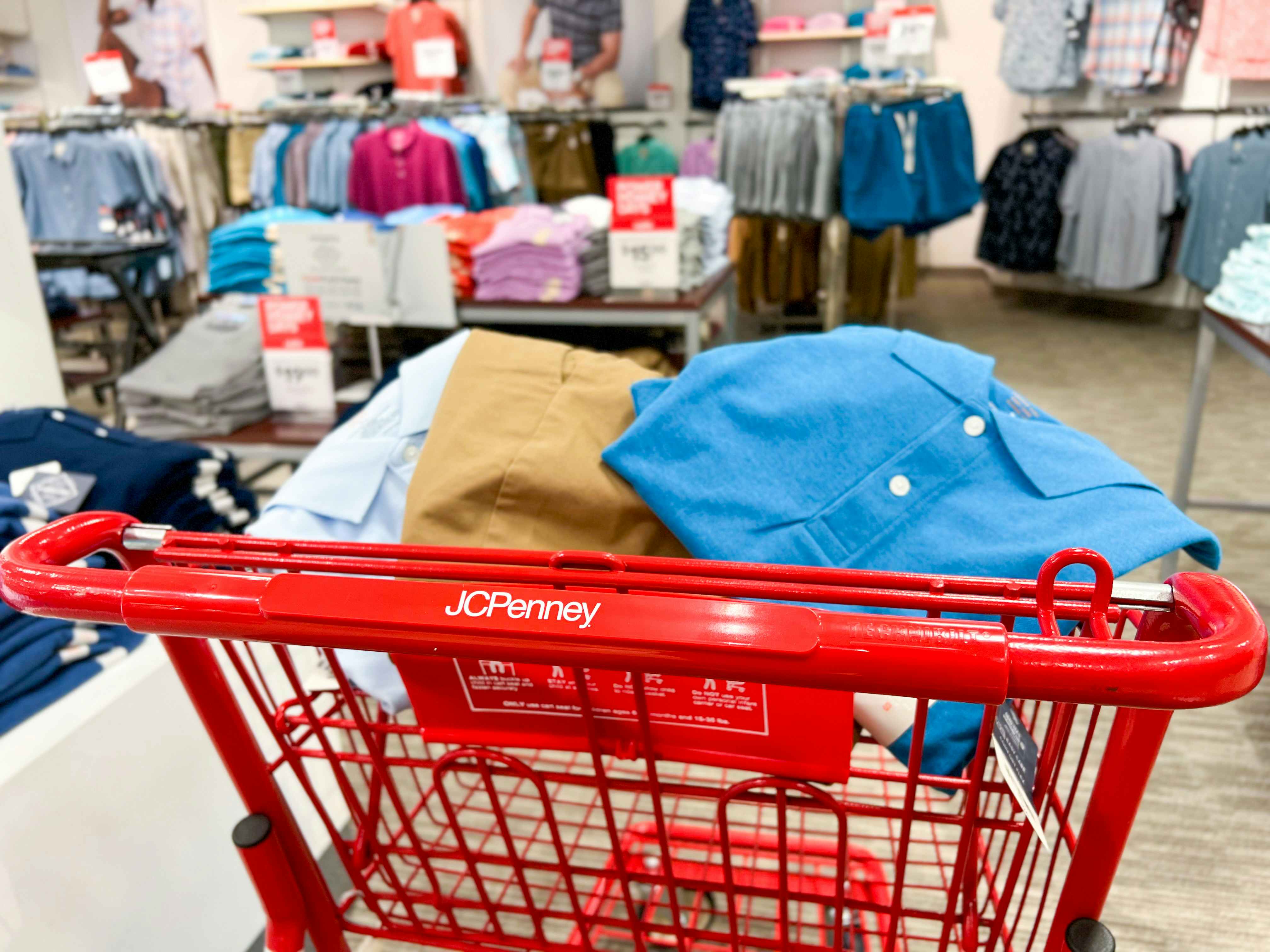 a JCPenney shopping cart with clothes in the basket
