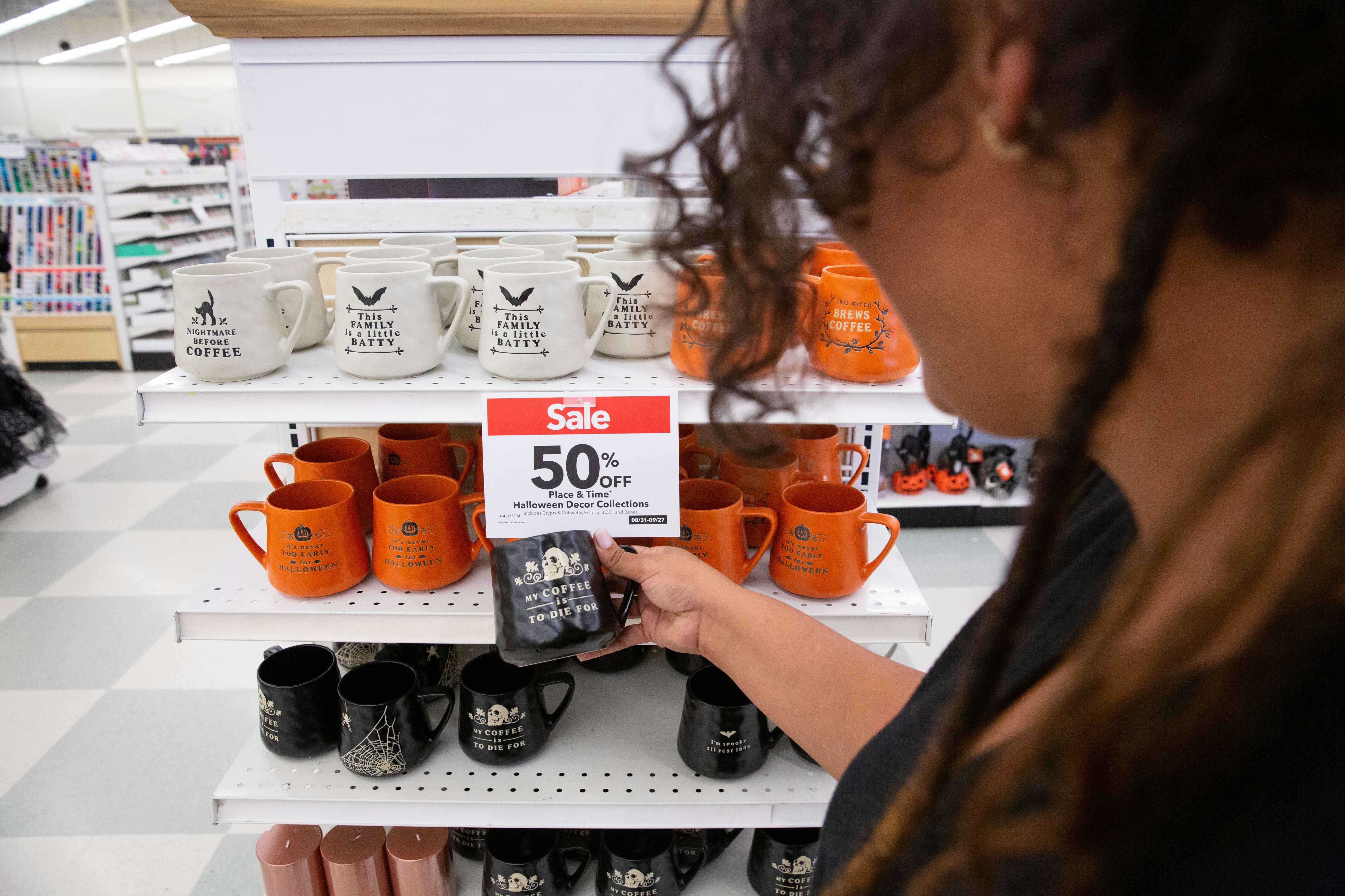 Model holding a halloween mug