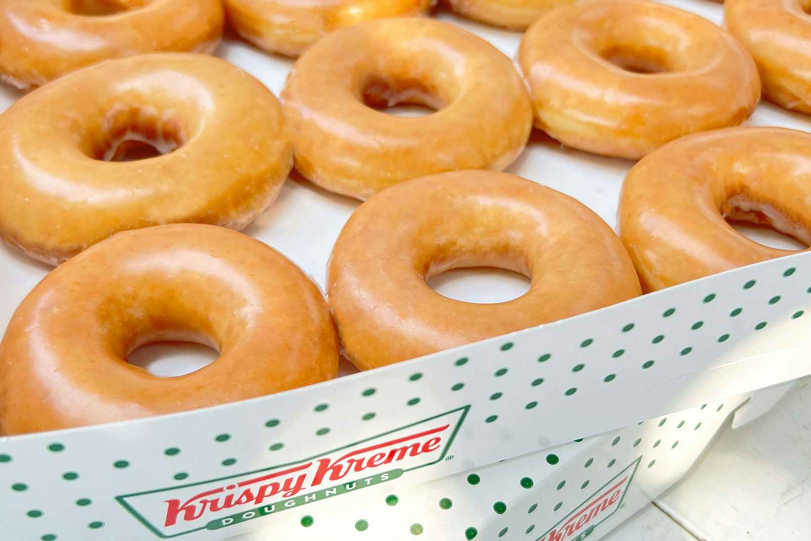 stacked boxes of krispy kreme original glazed doughnuts