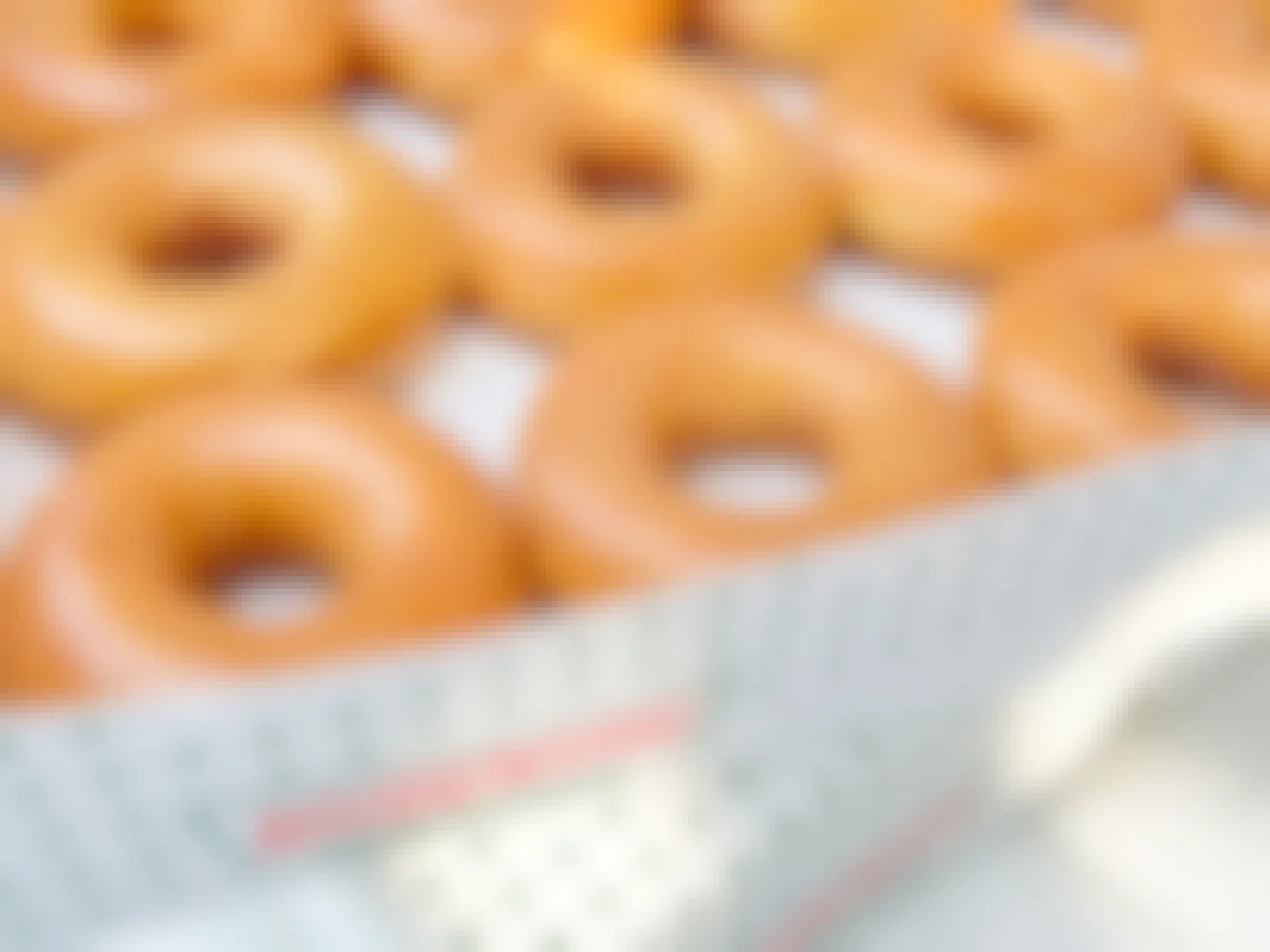 stacked boxes of krispy kreme original glazed doughnuts