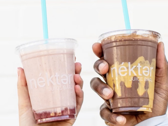 two people holding nektar juice smoothies. 