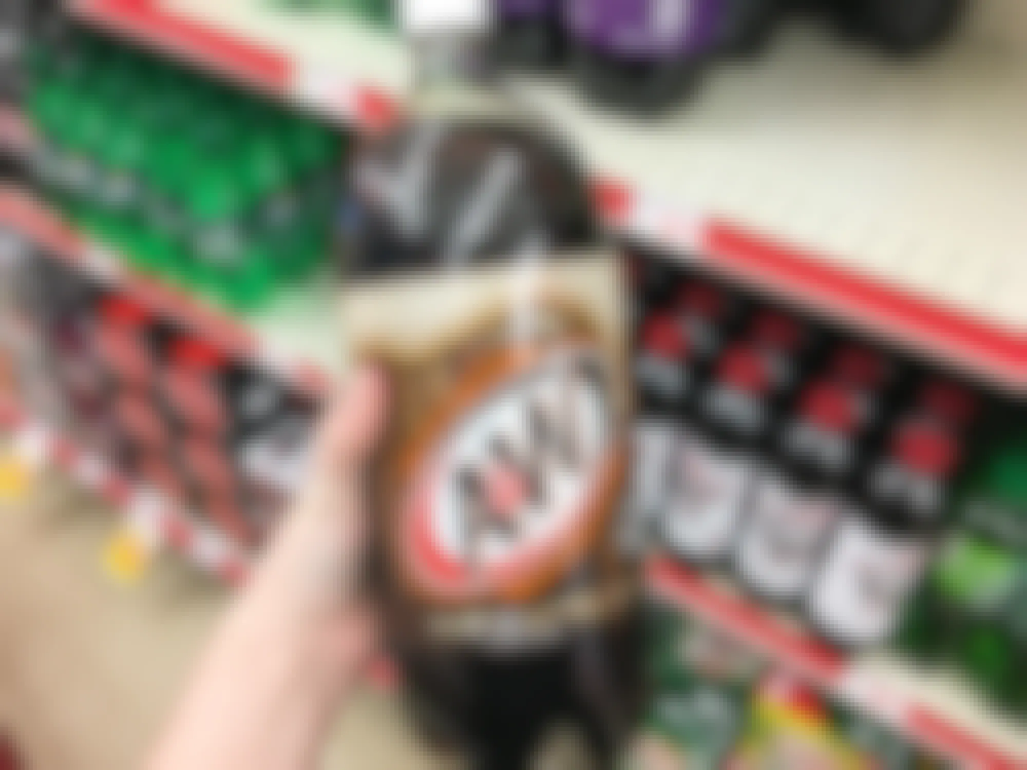 a hand holding up an A & W two liter 