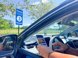 Person in their car holding a phone.