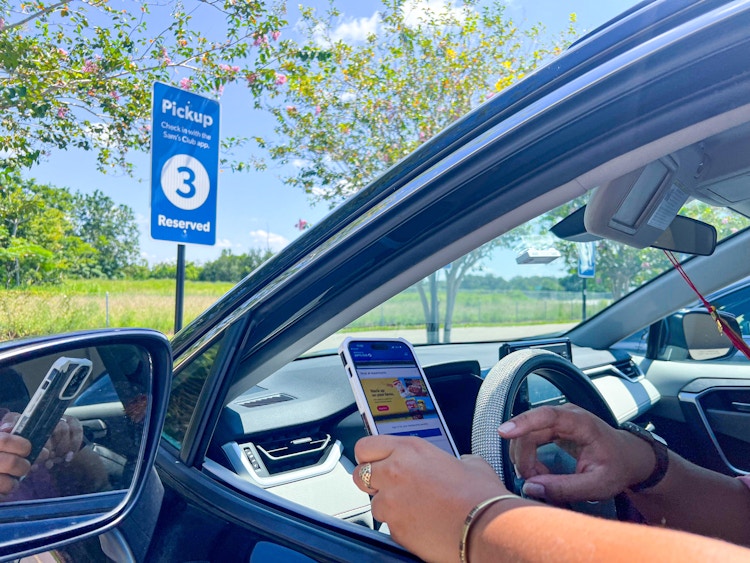 Person in their car holding a phone.