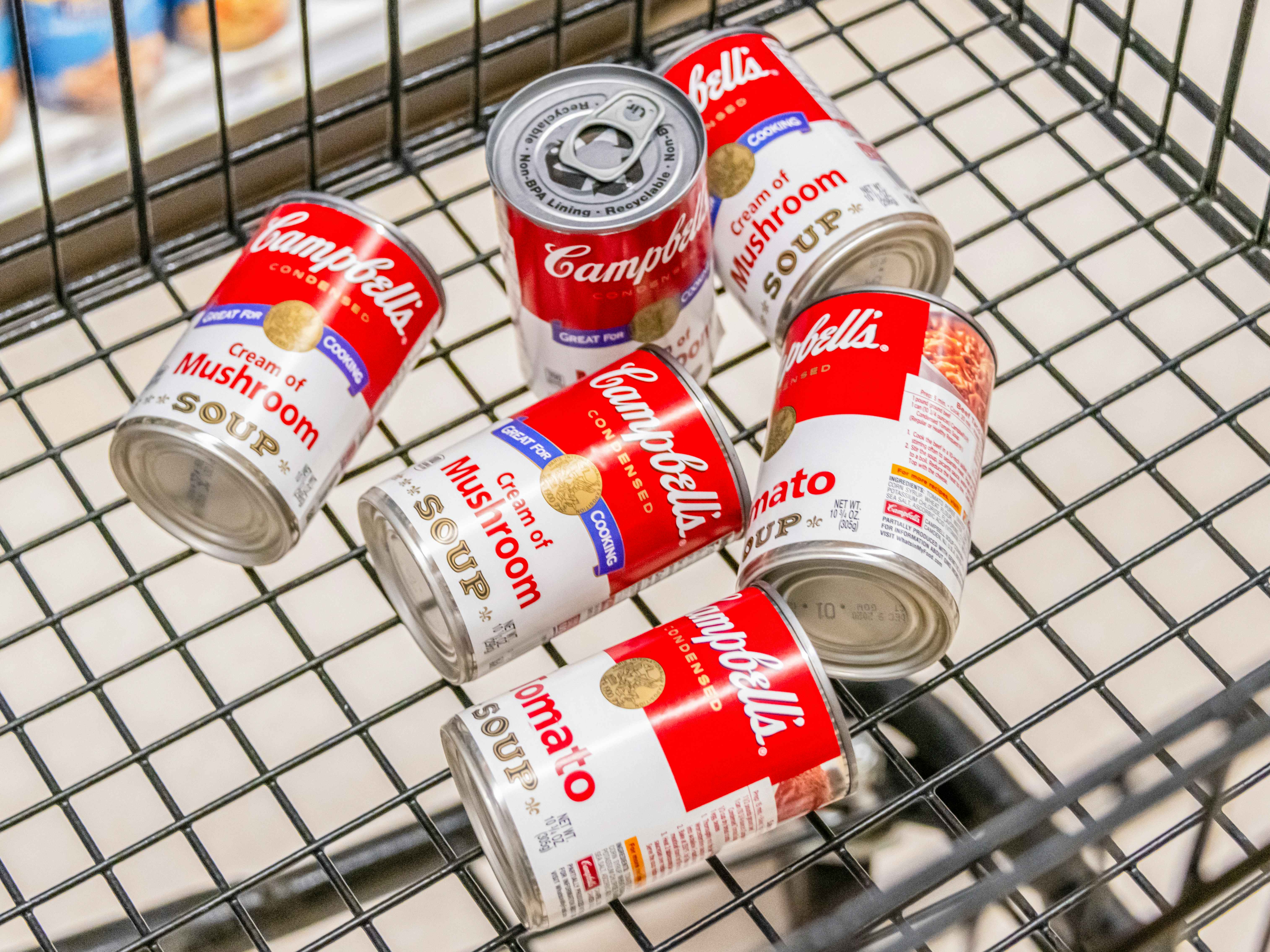 Assorted cans of Campbells brand soup in a cart 