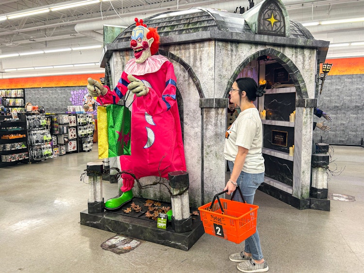 a person looking at spirit halloween animatronics 