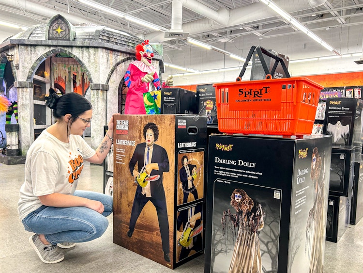 a person looking at spirit halloween animatronics 