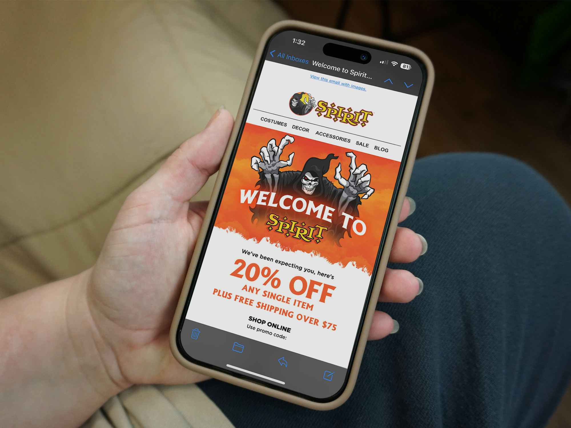 Someone reading the Spirit Halloween welcome email with a coupon for 20% off