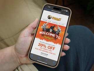 Someone reading the Spirit Halloween welcome email with a coupon for 20% off