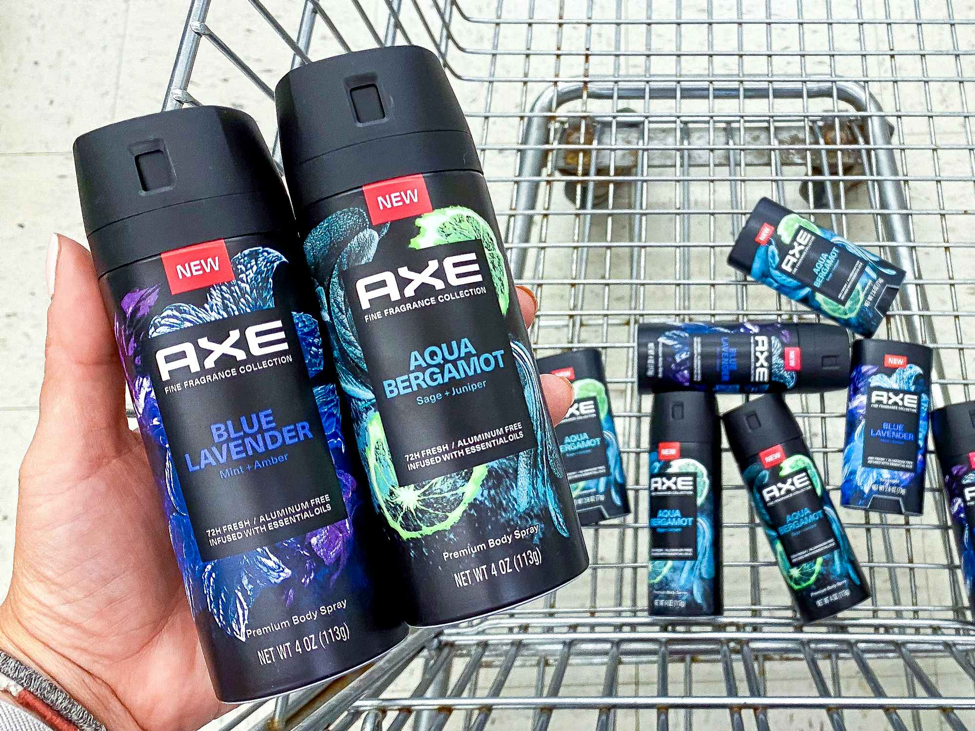 person holding axe fine fragrance collection near walgreens shopping cart