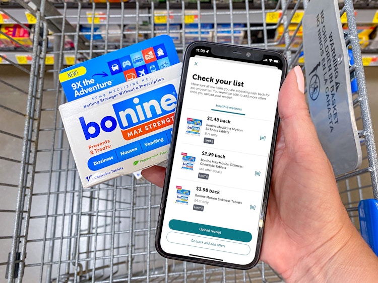 person holding packageg of bonine meclizine and phone with screenshot of ibotta deals in walmart