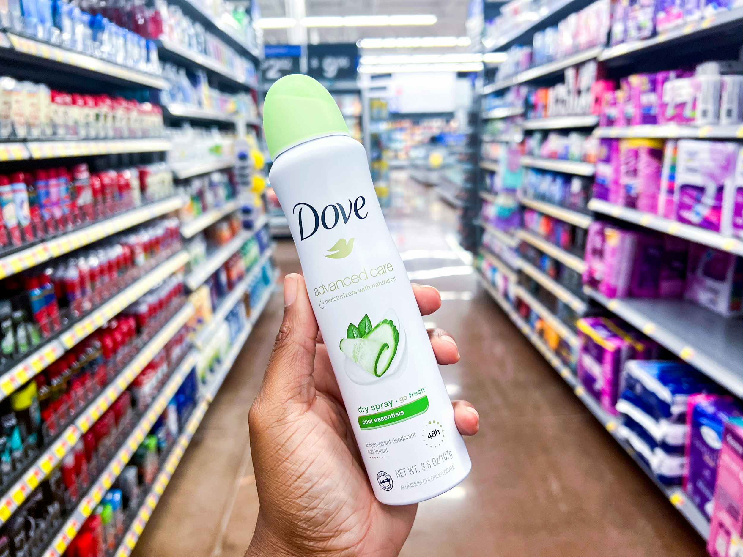 person holding a dove advanced care dry spray in cool essentials