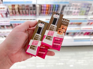 Someone holding up some Nyx The Brow Glue styler