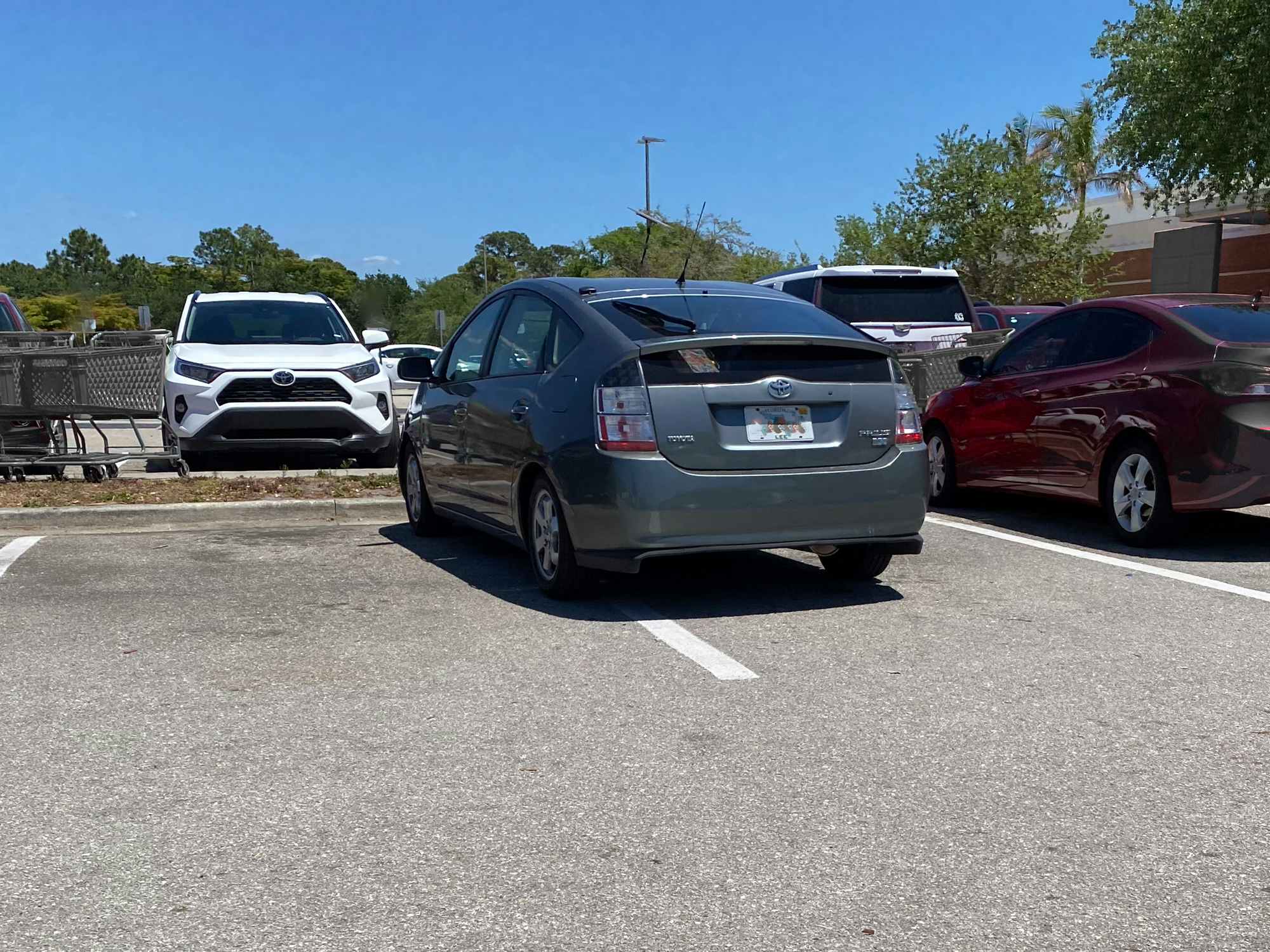 A car parked poorly in a parking lot