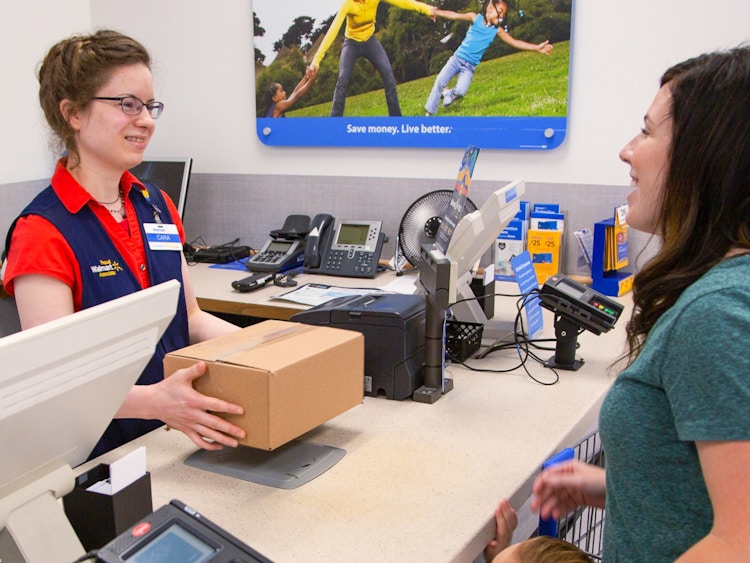 Someone talking to a Walmart associate at the Customer Service desk