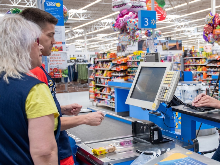 Someone at the Walmart checkout, talking to the employees