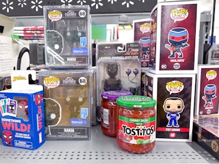 A couple jars of salsa sitting on a toy shelf at Walmart