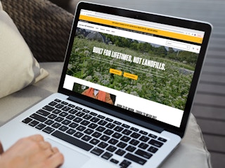 a person on their macbook looking at the carhartt website