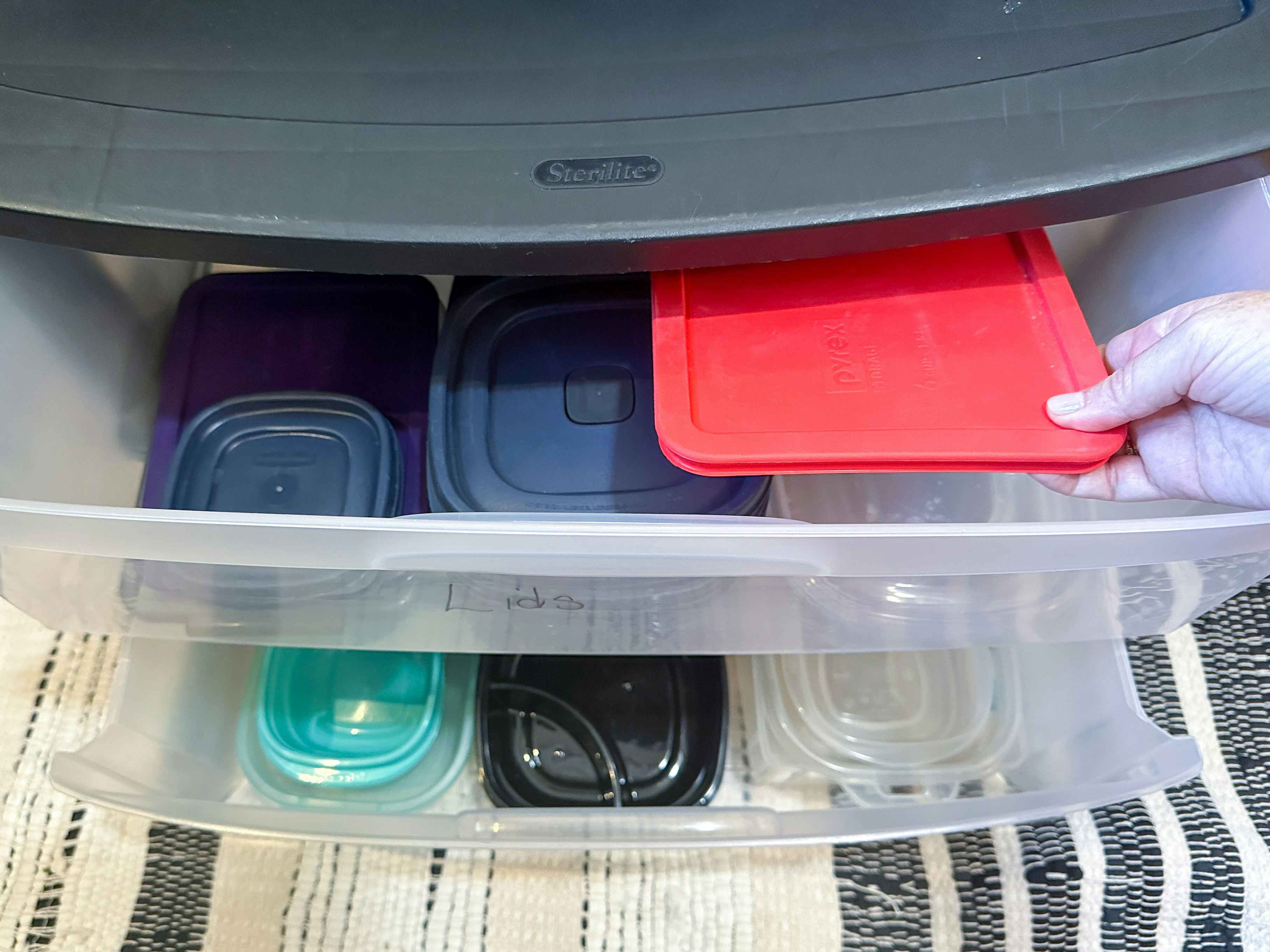 a plastic drawer system with tupperware put inside the drawers. 
