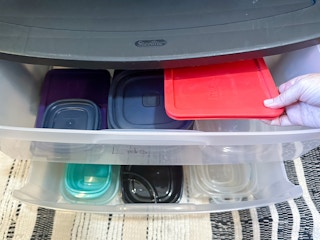 a plastic drawer system with tupperware put inside the drawers. 