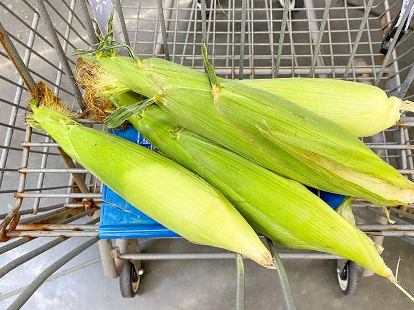 walmart shopping cart with ears of fresh sweet corn