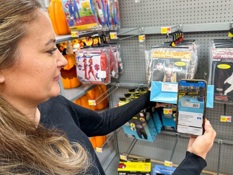 a person scanning a costume with walmart app in store 