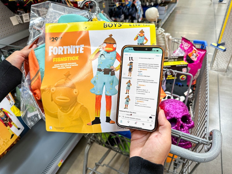 a person comparing prices on costumes in walmart vs amazon in store 
