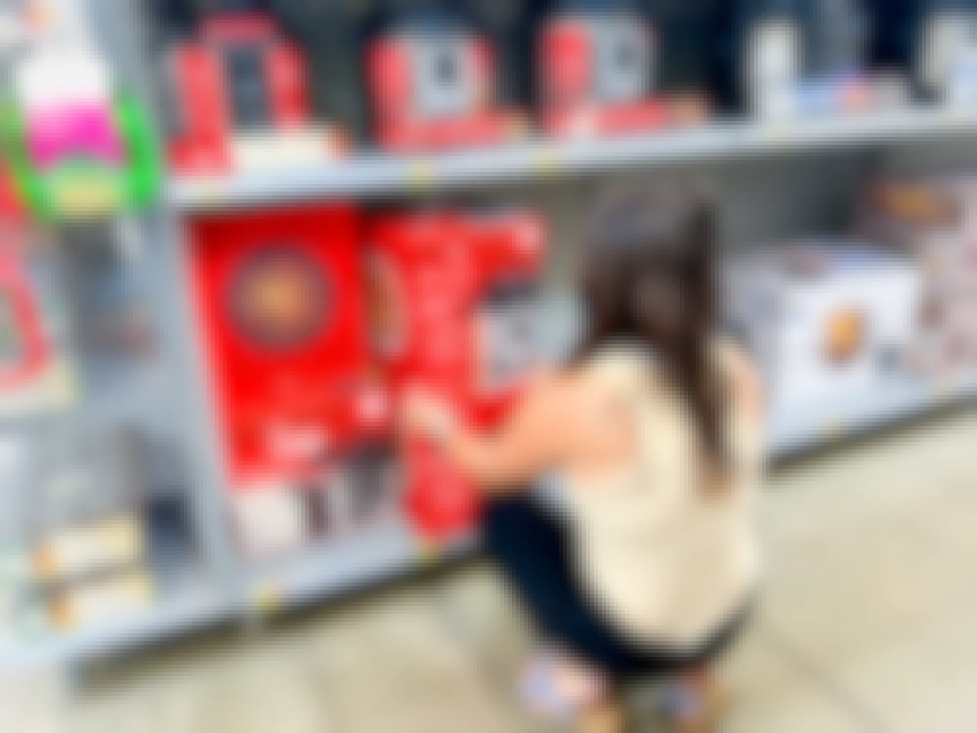 a person reaching for an instant pot in walmart