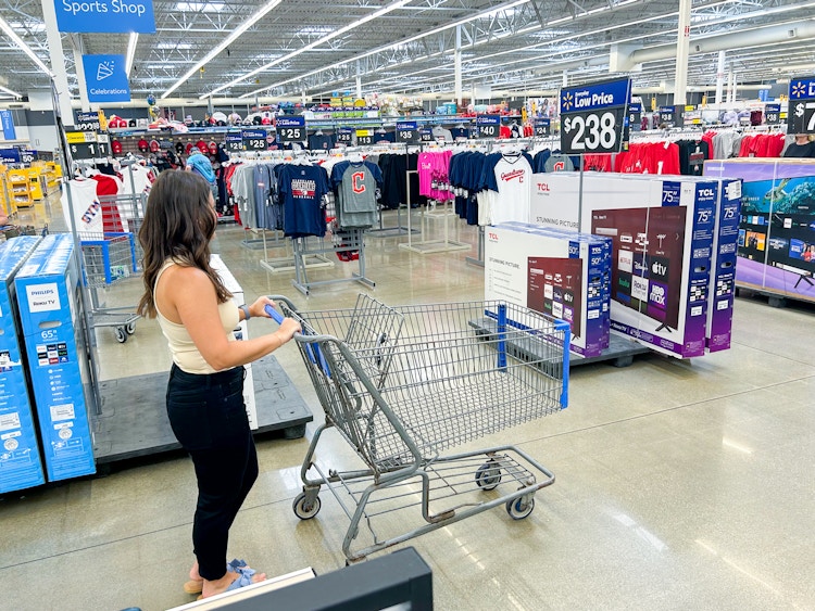 a person pushing a cart in walmart