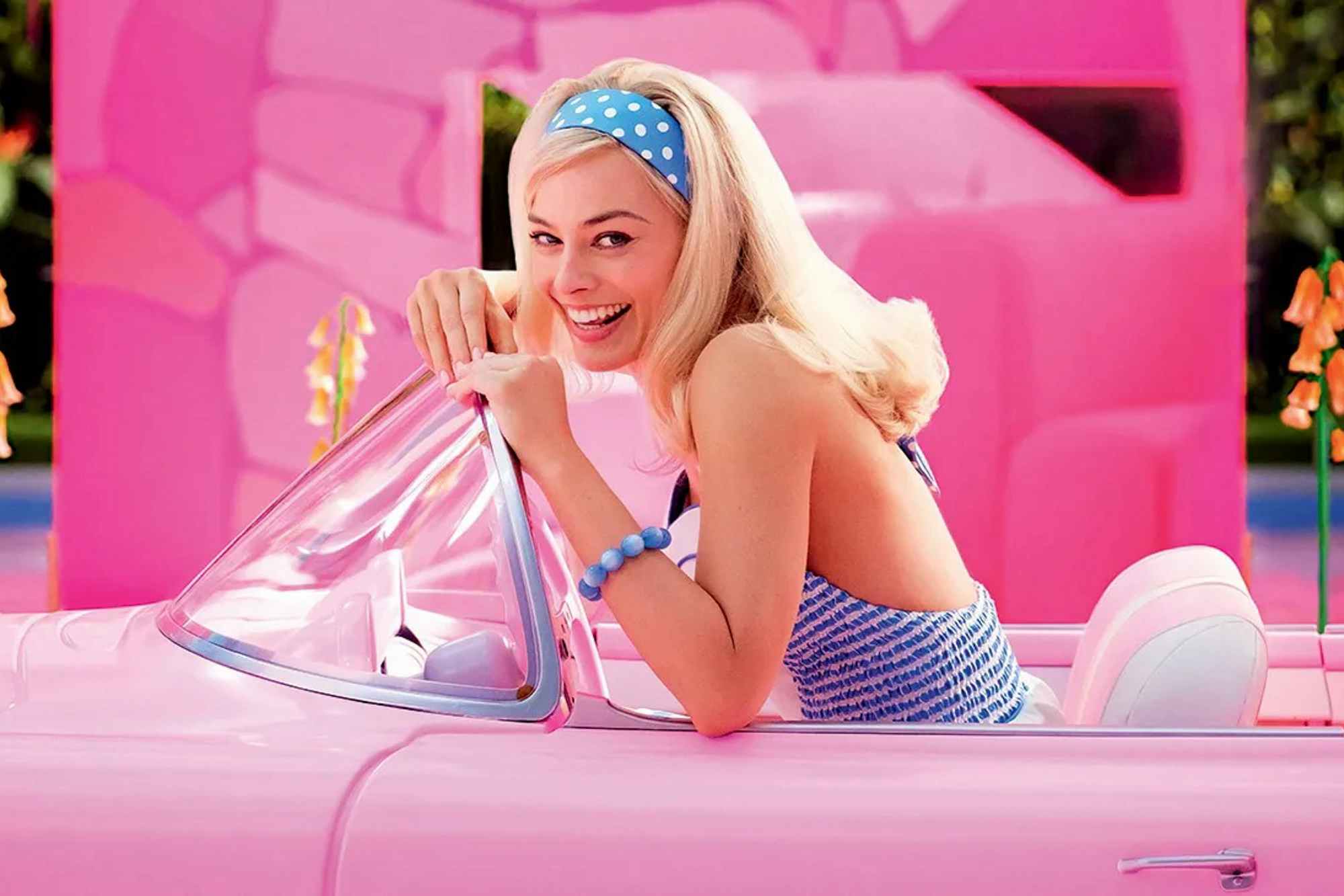 Barbie in a convertible, a shot from the Barbie Movie