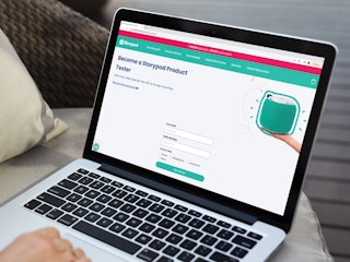 a person on the storypod website on their macbook