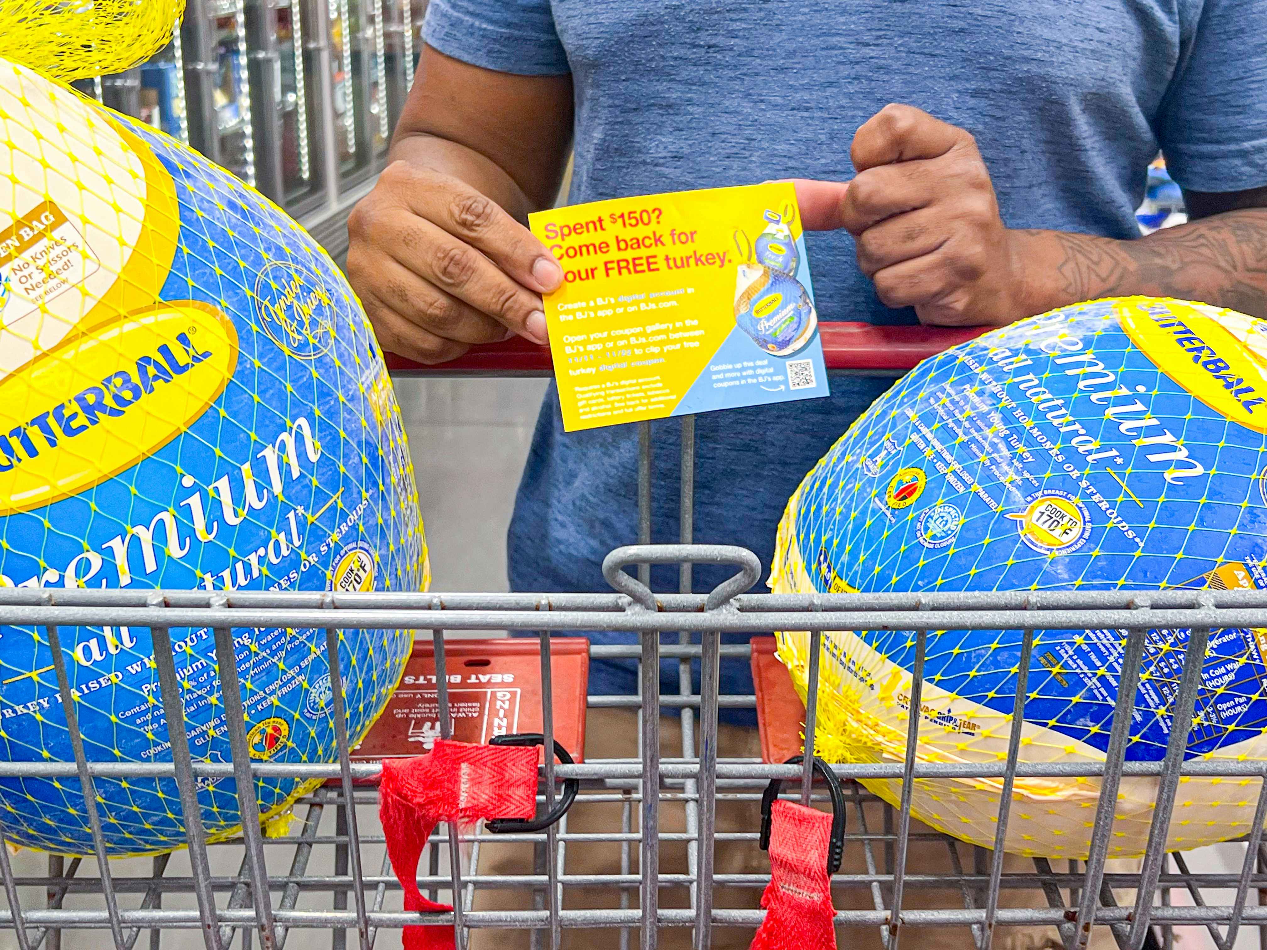 Person holding a pamphlet with details on the free butterball turkey with two fro 