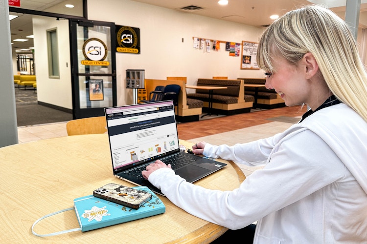 a college student on a laptop in college campus