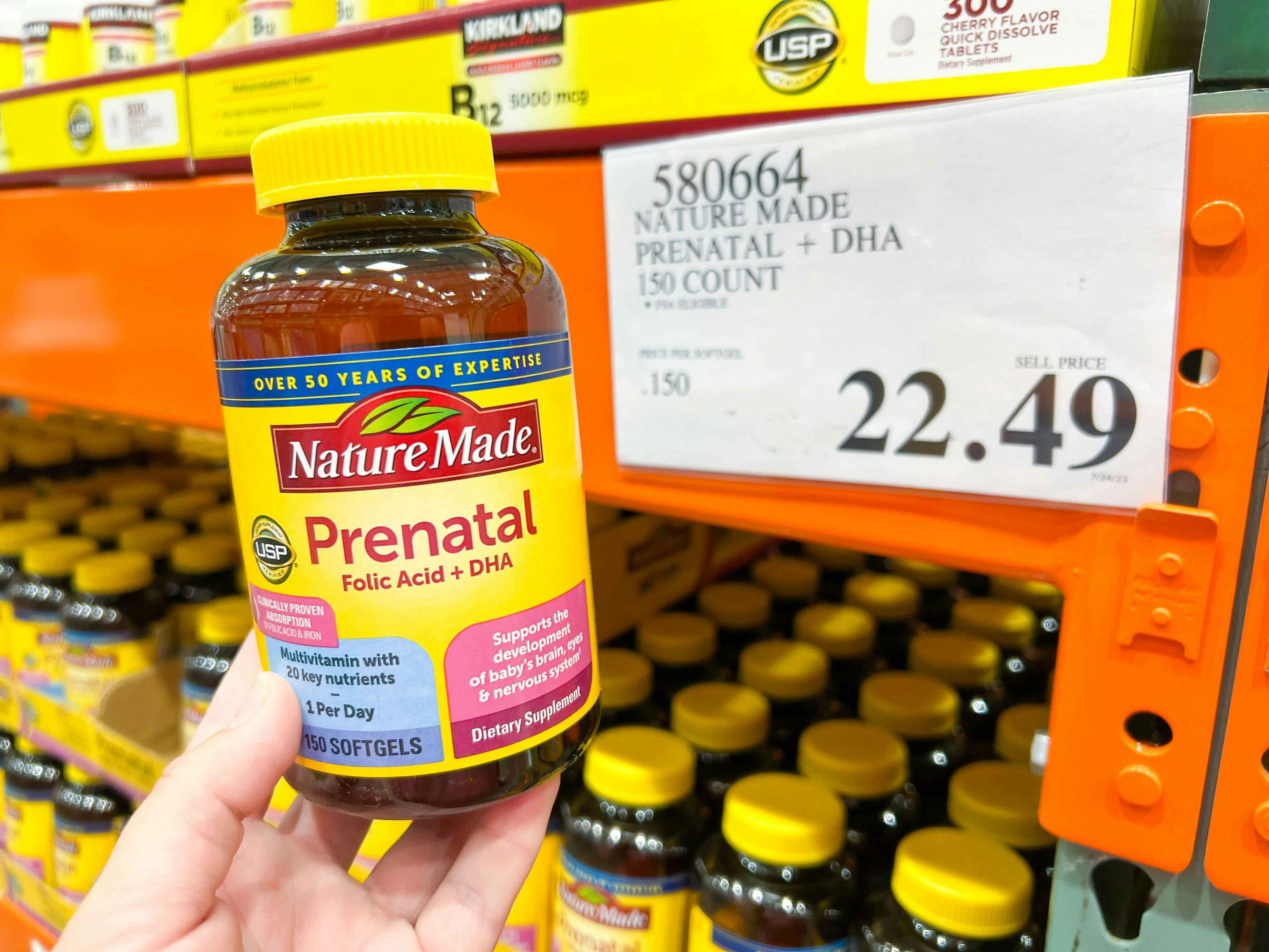 a person holding up nature made prenatal vitamins