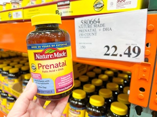 a person holding up nature made prenatal vitamins