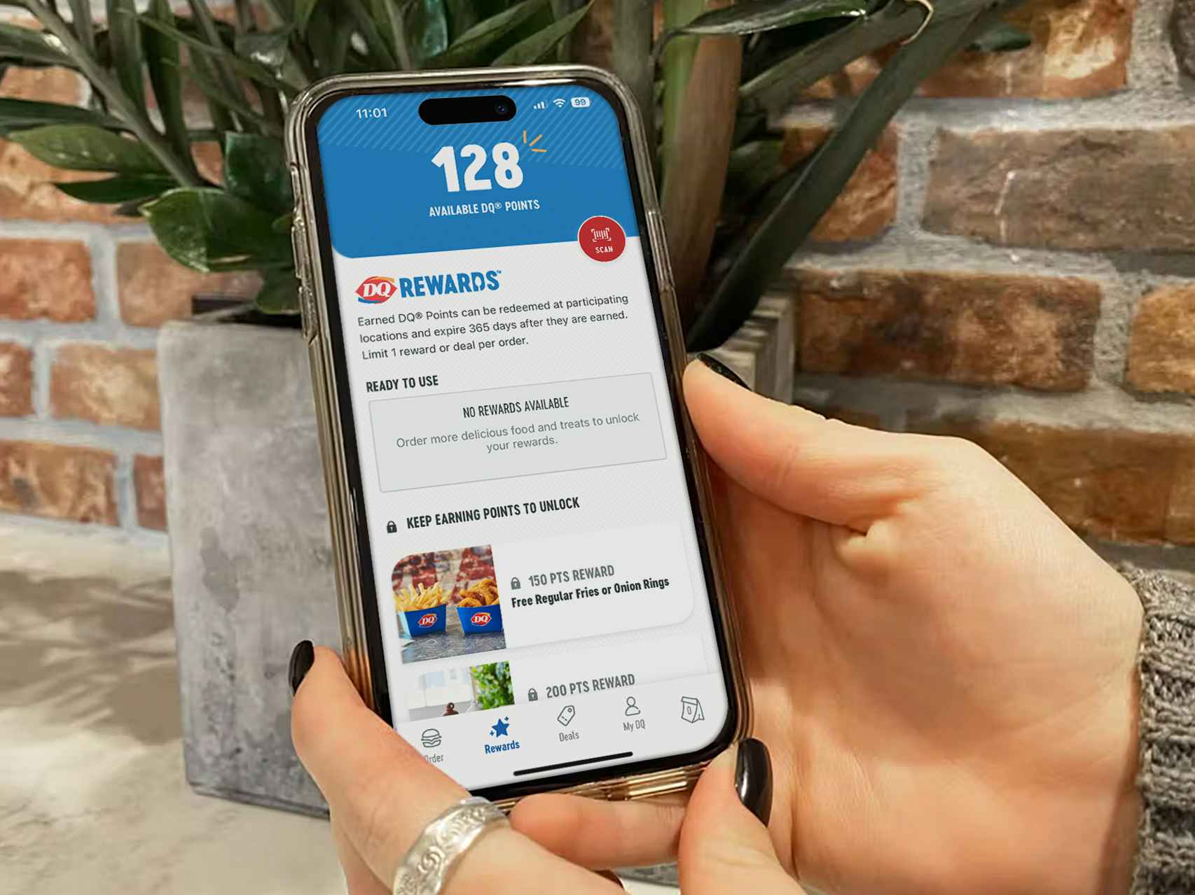 someone holding a phone displaying the rewards page on the Dairy Queen app