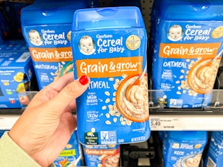 a hand holding up grain and grow gerber oatmeal at target