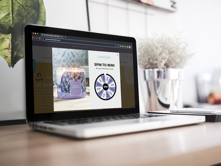 a laptop displaying the spinning wheel of discounts on the GooseCreek website