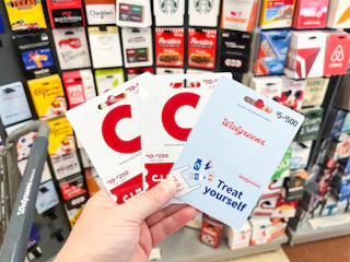 hand holding cinemark and walgreens gift cards with cart 2 1692740135 1692740135 scaled