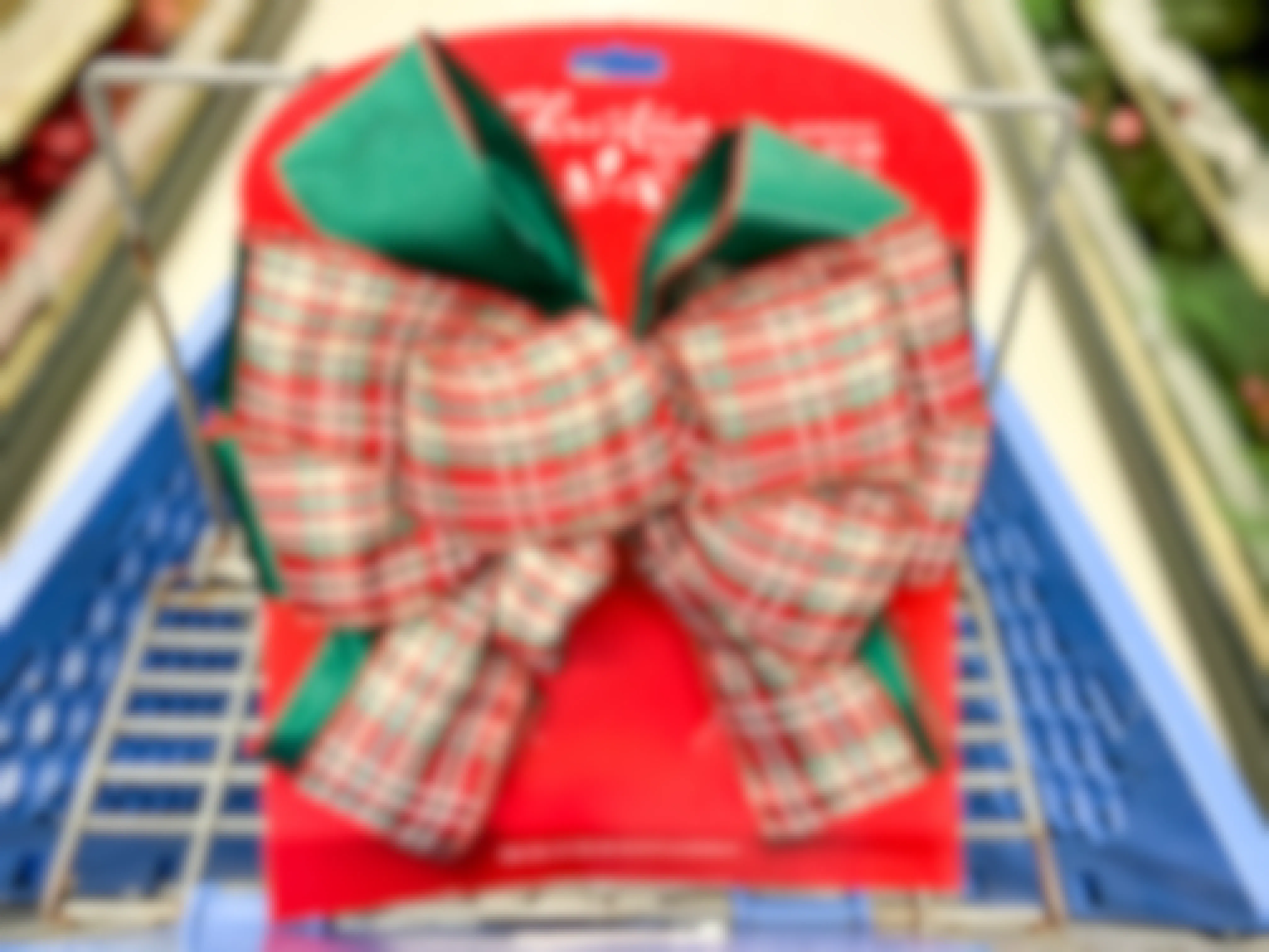 a christmas bow tree topper in a shopping cart