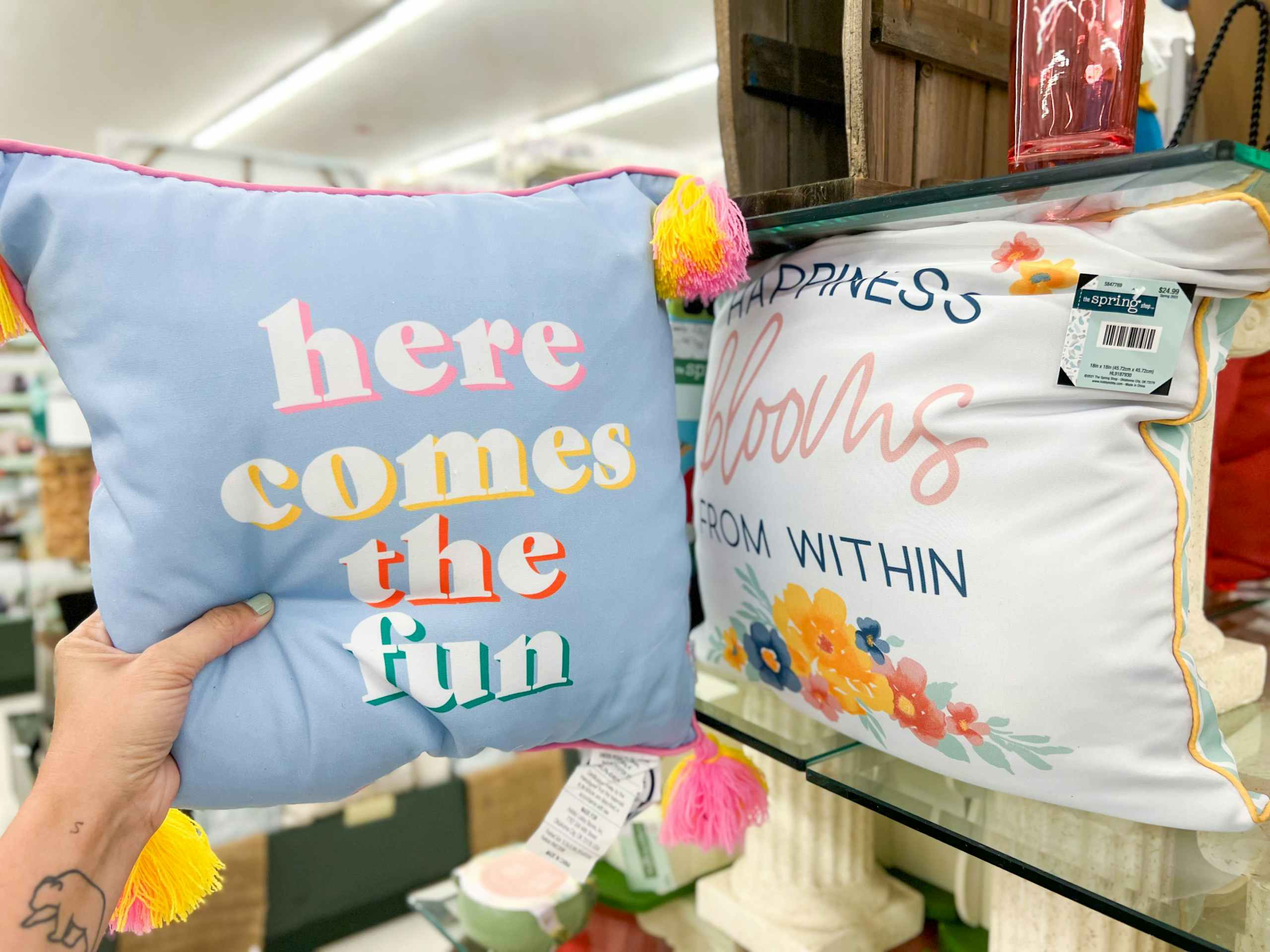 hand holding up spring throw pillows
