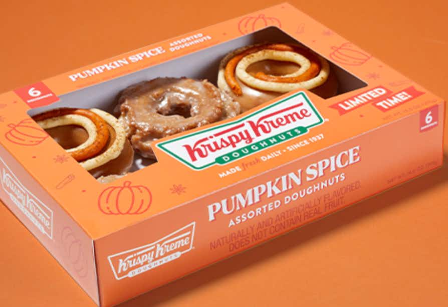 a pack of pumpkin spice doughnuts from Krispy Kreme from the grocery store against an orange background