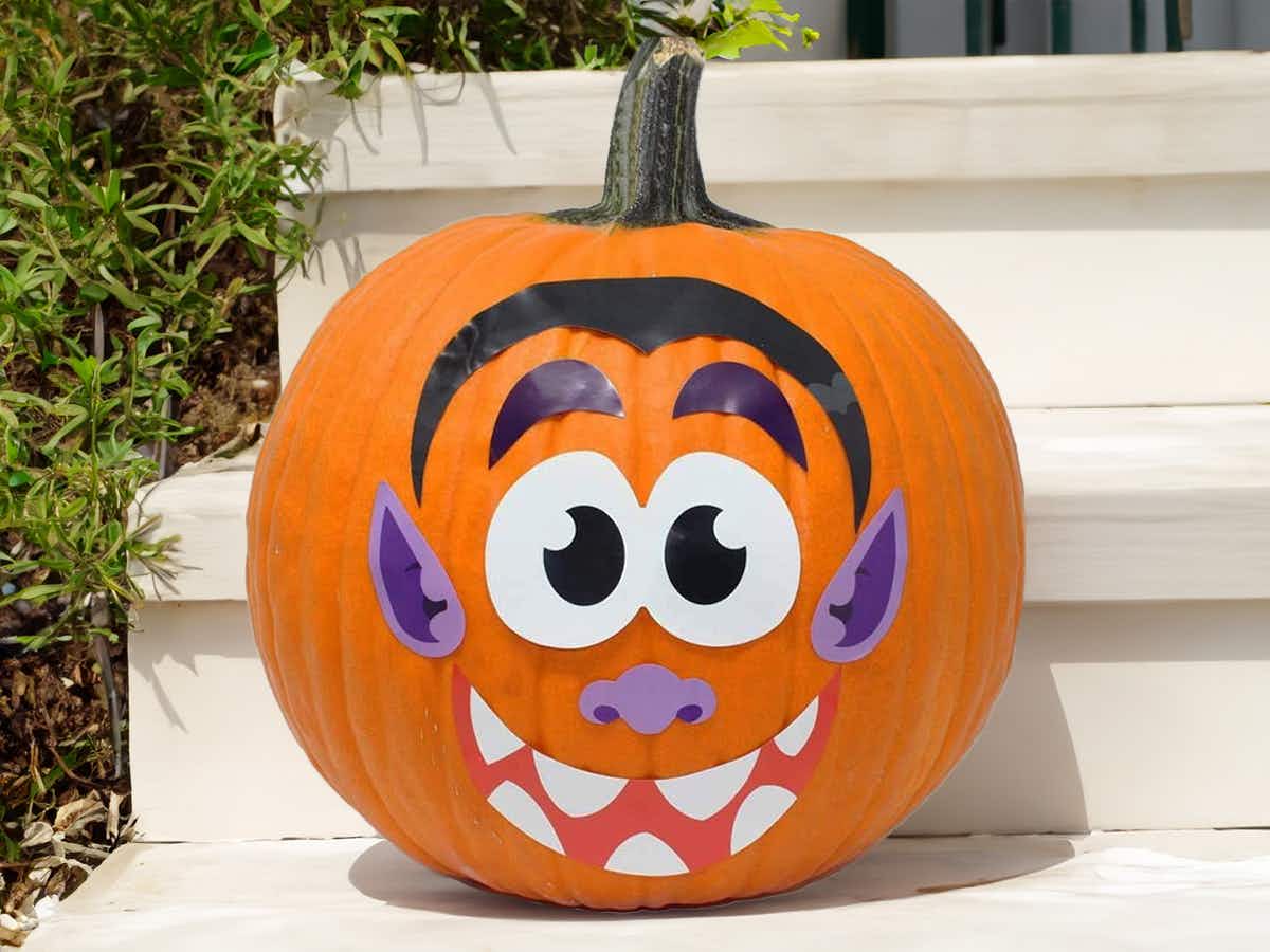 a pumpkin decorated with stickers