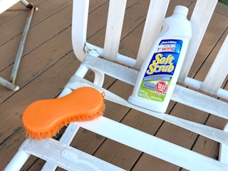 soft scrub cleanser with bleach and scrub brush on vinyl patio furniture