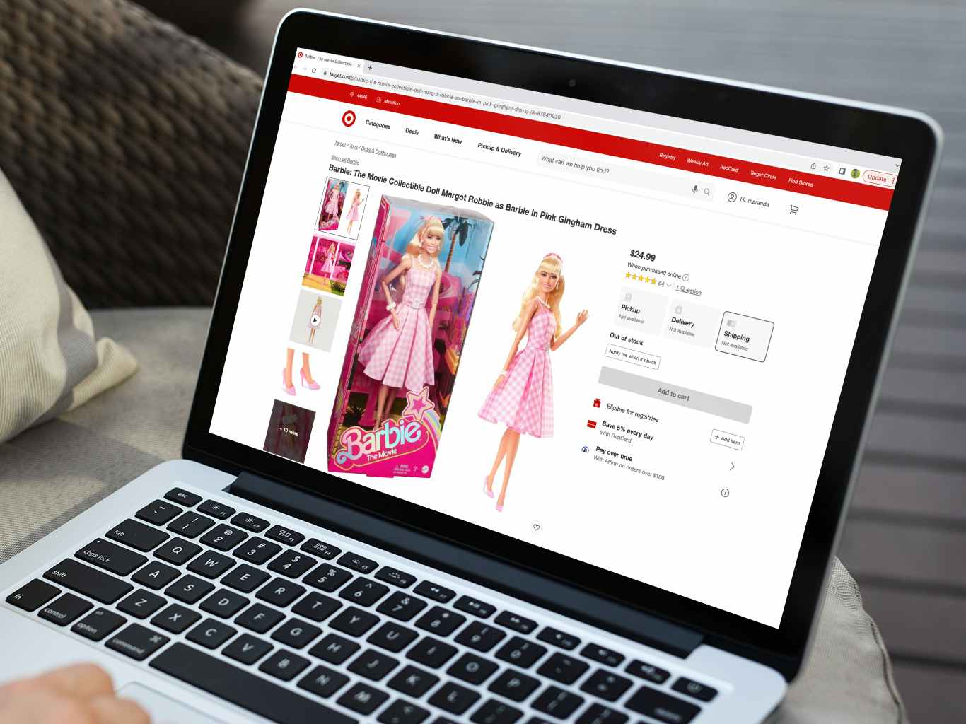 a person looking at the target website for the barbie movie doll