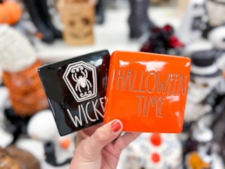 hand holding up rae dunn halloween decor