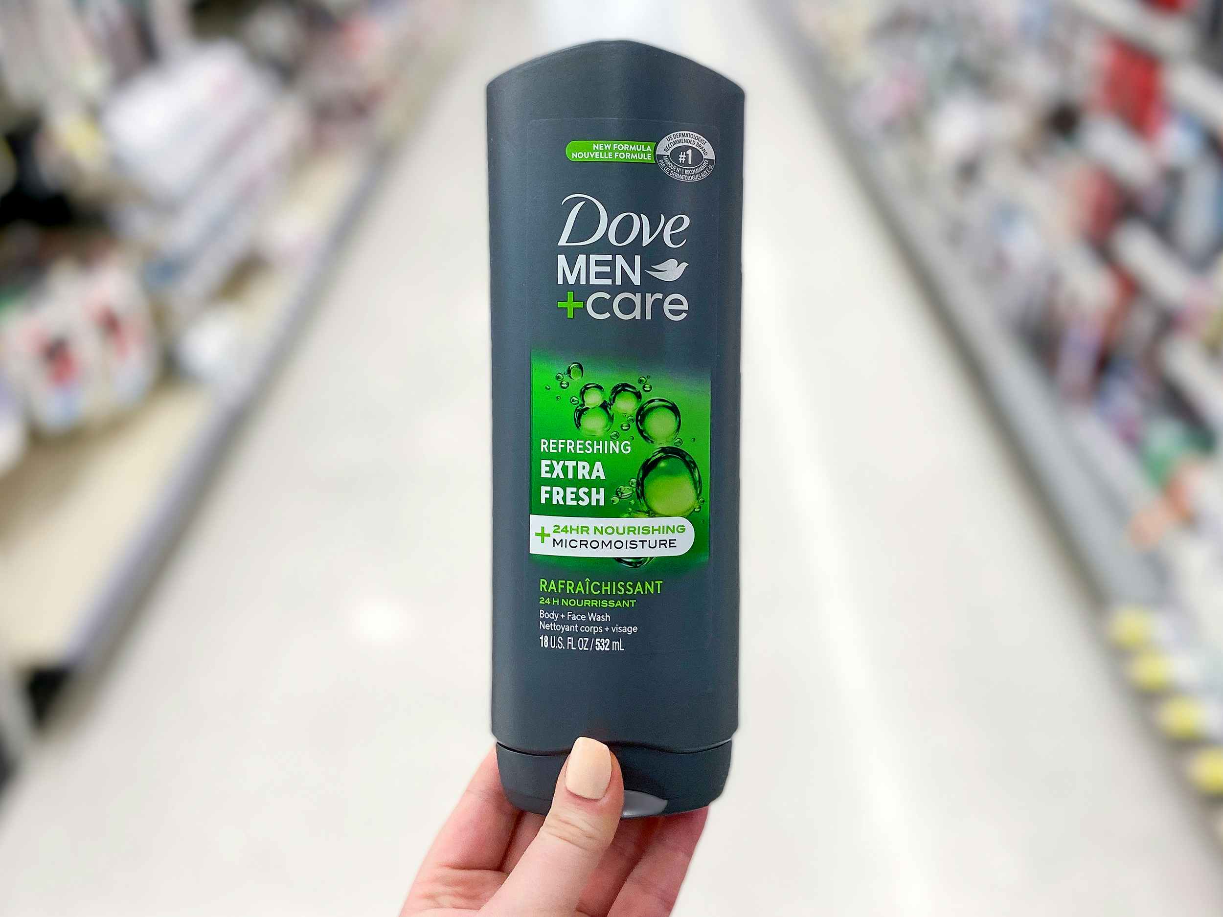 hand holding a bottle of dove men+care body wash
